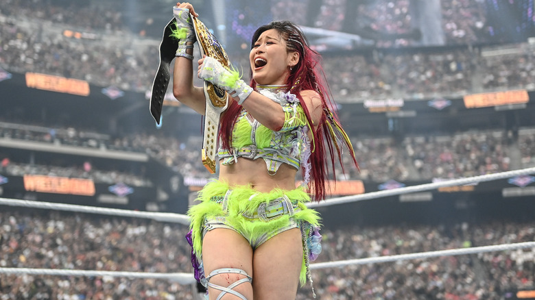 IYO SKY celebrates with her title belt after winning at WWE WrestleMania 41