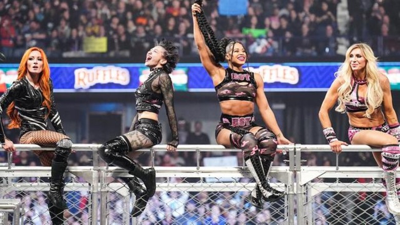 Becky Lynch, Shotzi, Bianca Belair, and Charlotte Flair celebrate winning WarGames