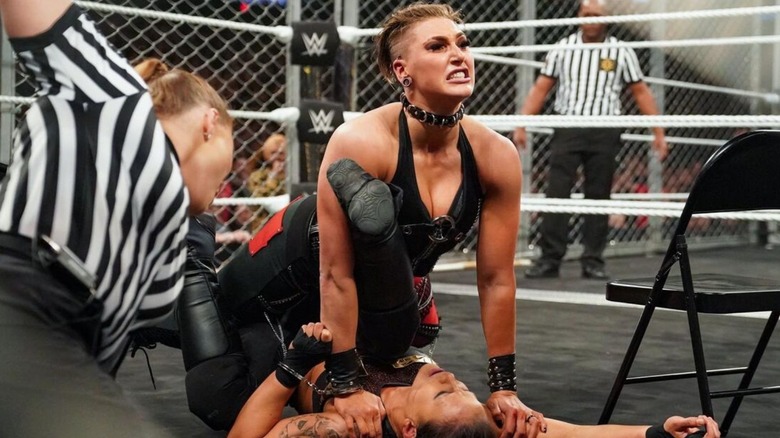 Referee Jessika Carr counts as Rhea Ripley pins Shayna Baszler's shoulders to the mat in the first-ever women's WarGames match.