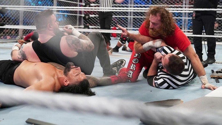 Kevin Owens and Sami Zayn stare at each other inside WarGames in 2022