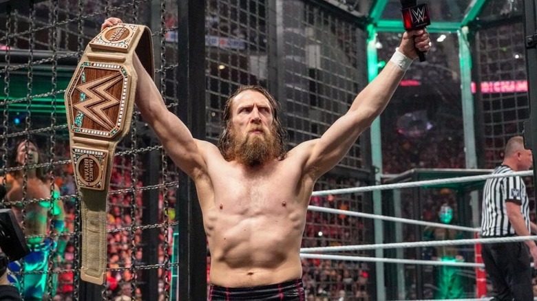 Daniel Bryan poses on the steps, microphone in hand, after cutting a promo before the Elimination Chamber 2019 match where he defended his WWE Championship.