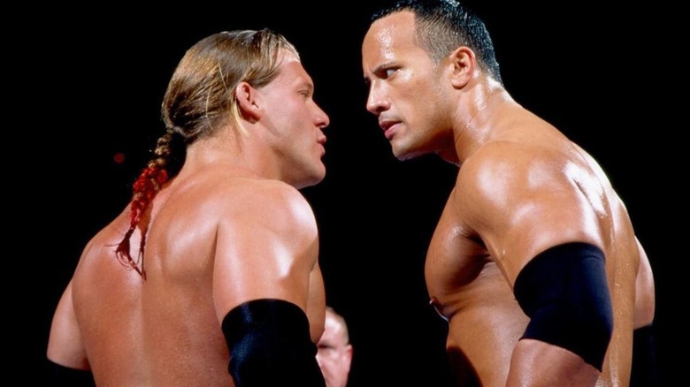Chris Jericho and The Rock stare each other down in the middle of the ring during their match for the Unified WWF Championship at the 2002 Royal Rumble.