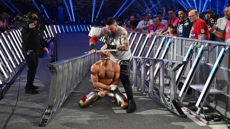 Kevin Owens assaults Cody Rhodes with a ladder at WWE Royal Rumble 2025