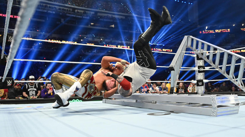 Cody Rhodes tosses himself and Kevin Owens onto the edge of a ladder.