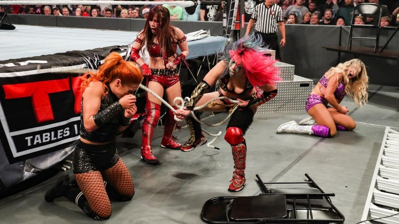 Kabuki Warriors attack Becky Lynch and Charlotte Flair outside of the ring