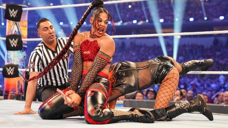 Bianca Belair puts Becky Lynch in her own Dis-Arm-Her submission during their match at WrestleMania 38.