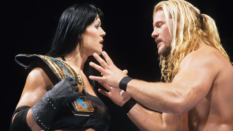 Chris Jericho gestures at the Intercontinental Championship on Chyna's shoulder.