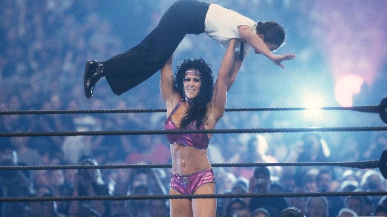Chyna military presses Ivory over her head during their match for the WWF Women's Championship at WrestleMania 17.
