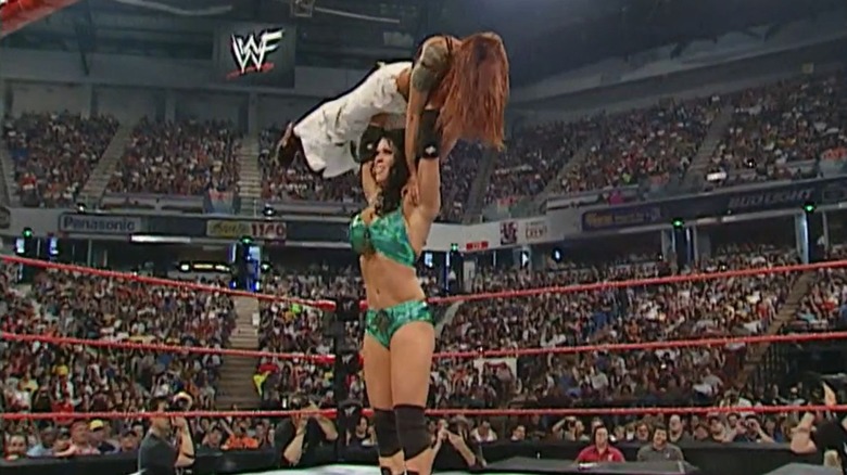 Chyna military presses Lita above her head during their match at Judgment Day 2001.