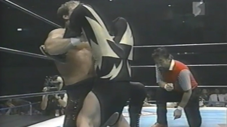 Wild Pegasus cinches in a submission on Black Tiger II [Eddie Guerrero]