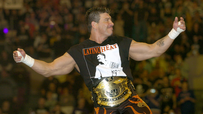 Eddie Guerrero poses on the ropes for fans, WWE Championship around his waist, before a match. (Photo by Kevin Mazur/WireImage)