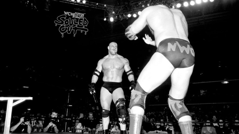Goldberg stares across the ring from Scott Hall at WCW Souled Out 1999 before their ladder match.