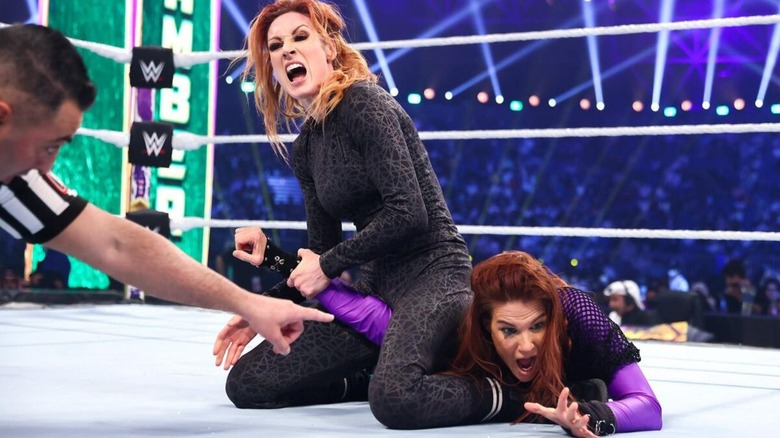 Becky Lynch puts Lita in the Dis-Arm-Her in the middle of the ring during their match at Elimination Chamber 2022.