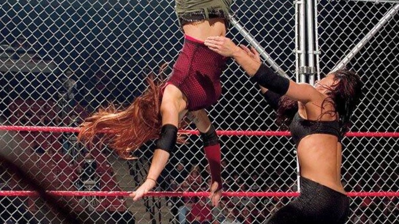 Victoria hits a move off the ropes to Victoria during their steel cage match on "WWE Raw" in November 2003.