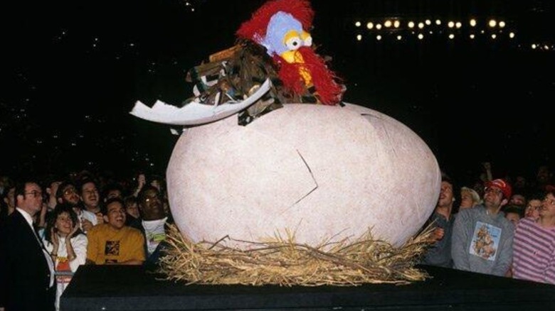 The Gobbledy Gooker hatches on top of the commentary desk during Survivor Series 1990.