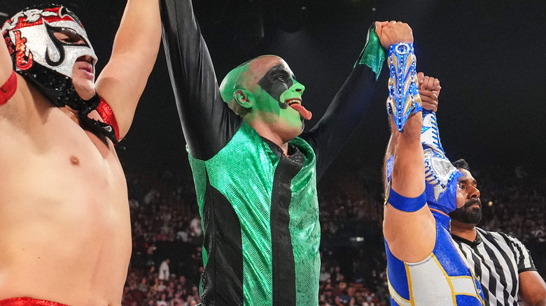Mr. Iguana celebrates with Octagon Jr and Aero Star