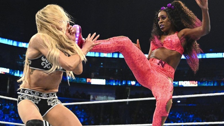 Naomi boots Charlotte Flair in the face during their match for the SmackDown Women's Championship in the main event of a February 2022 episode of the blue brand.