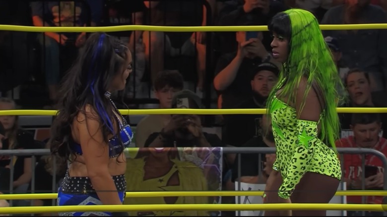 Deonna Purrazzo and Trinity stare each other own in the middle of the ring before locking up to kick off their match at Slammiversary in 2023.