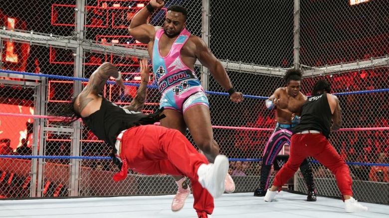 Big E hits one of The Usos with a forearm while the other Uso brother faces off against Xavier Woods in the corner during a Hell in a Cell match in 2017.