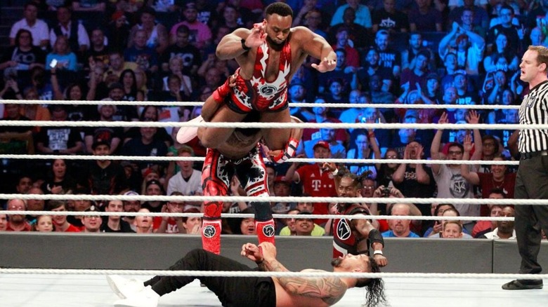 Big E hits a splash from the top of Xavier Woods' shoulders onto Jey Uso below during their match at SummerSlam 2017.
