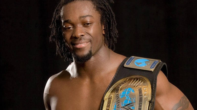 Kofi Kingston poses with the Intercontinental Championship in a backstage photoshoot for WWE.com.