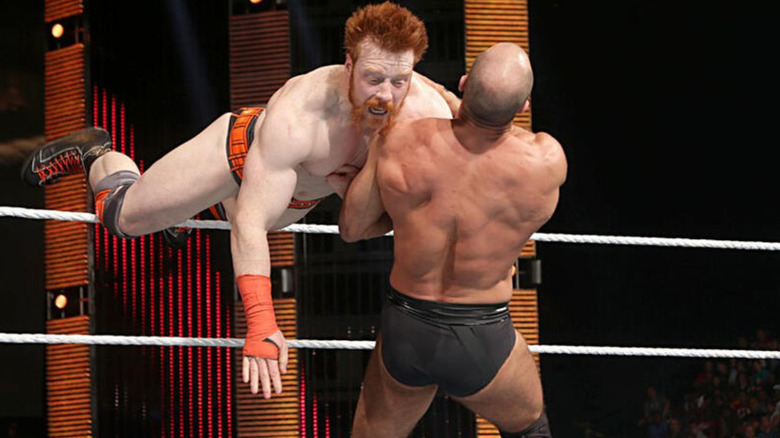 Sheamus delivering a flying shoulder tackle to Cesaro