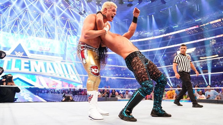 Cody Rhodes locks Seth Rollins' head in for a Cross-Rhodes.