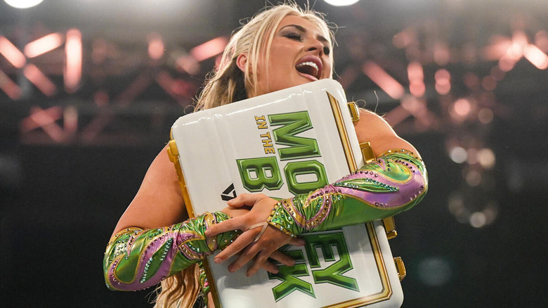 Tiffany Stratton embraces her newly-won Money in the Bank briefcase.
