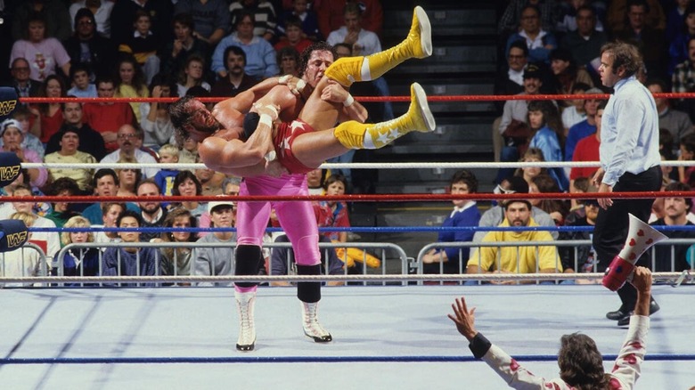 Bret Hart lifting Randy Savage in the ring at "WWE Saturday Night's Main Event"