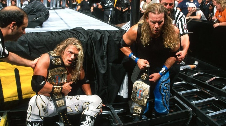 Edge and Christian holding their WWF tag titles after the first TLC at SummerSlam 2000