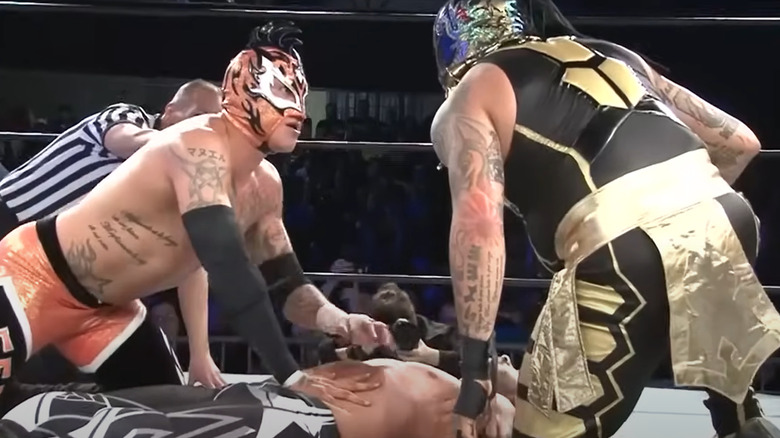 Penta and Fenix both go for a pinfall