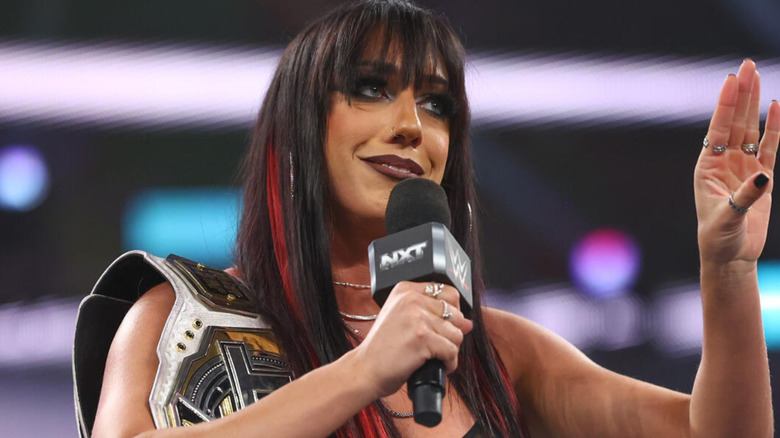 Jacy Jayne is holding a microphone