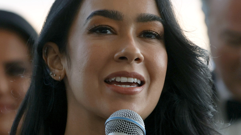 AJ Mendez Holding a Microphone