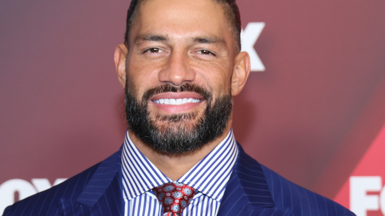 Roman Reigns smiles at a press event 