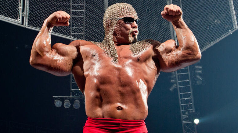 Scott Steiner flexes in the ring as a cage comes down around him before a match.