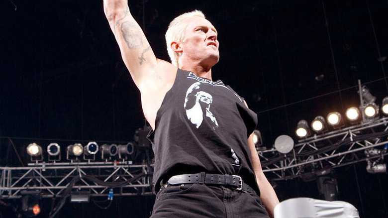 ECW's Sandman stands on the turnbuckle and poses for fans before a match.