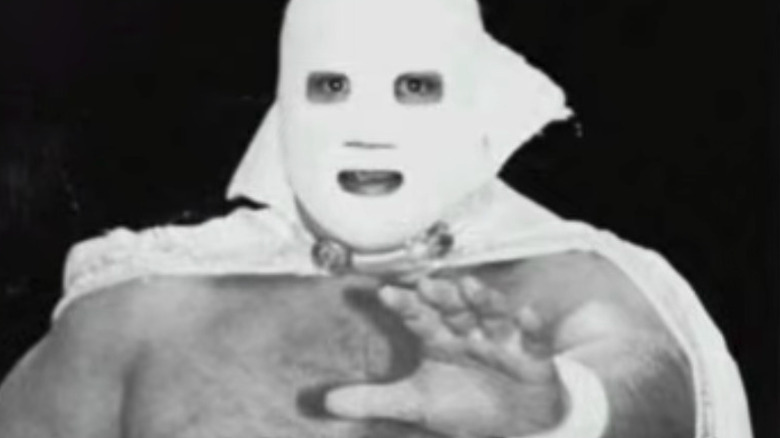 Gran Markus Jr. wearing his mask, poses for a photo in his ring gear ahead of a match.
