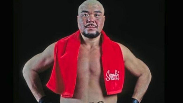 Tadao Yasuda poses with Antonio Inoki's signature red scarf around his neck