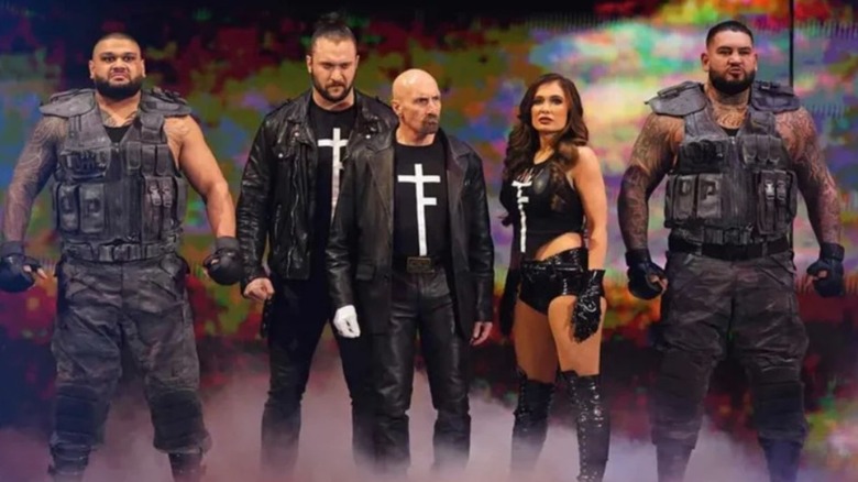 The Authors of Pain and Paul Ellering stand on the stage with Karrion Kross and Scarlett before a match on WWE TV.