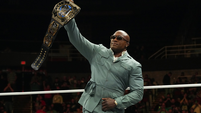 Bobby Lashley holds up the AEW Tag Team Championship in the ring during a promo segment on "AEW Dynamite."