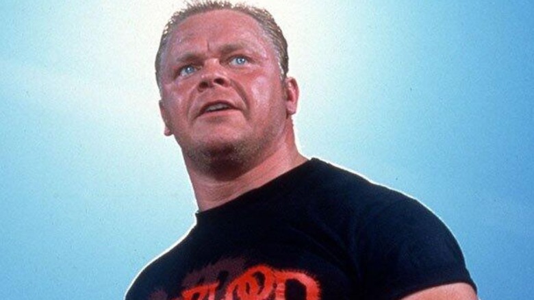 Shane Douglas stands in the middle of the ring before cutting a promo on an episode of WCW.