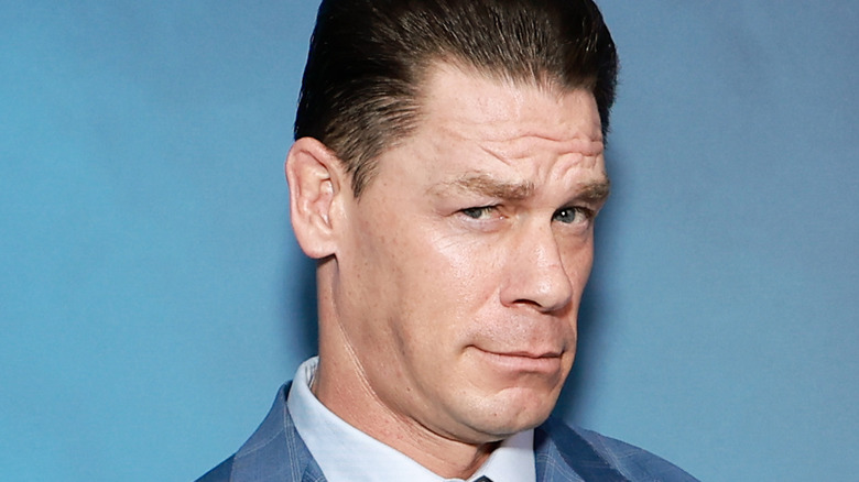 John Cena posing for a photo with a dubious expression
