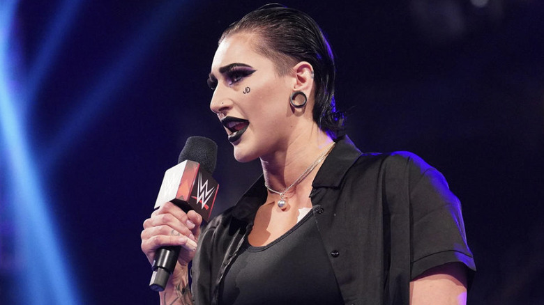 Rhea Ripley in the ring, talking into a microphone