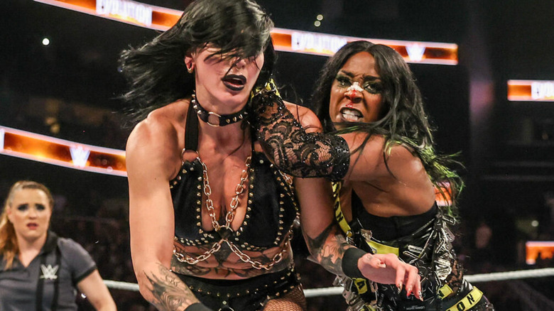 WWE star Naomi preparing to launch Rhea Ripley into a ring post