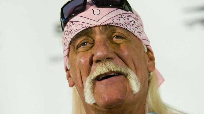 Hulk Hogan wearing a pink bandana with sunglasses on his head