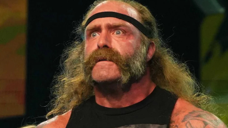 The Butcher wearing a black headband