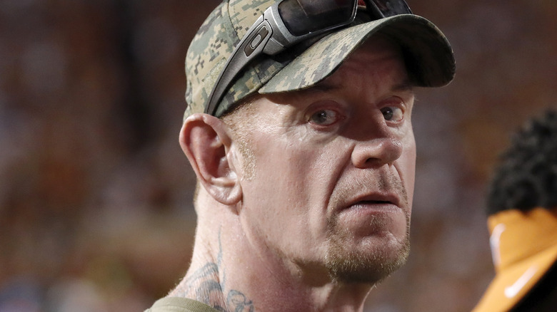 The Undertaker in a camo hat