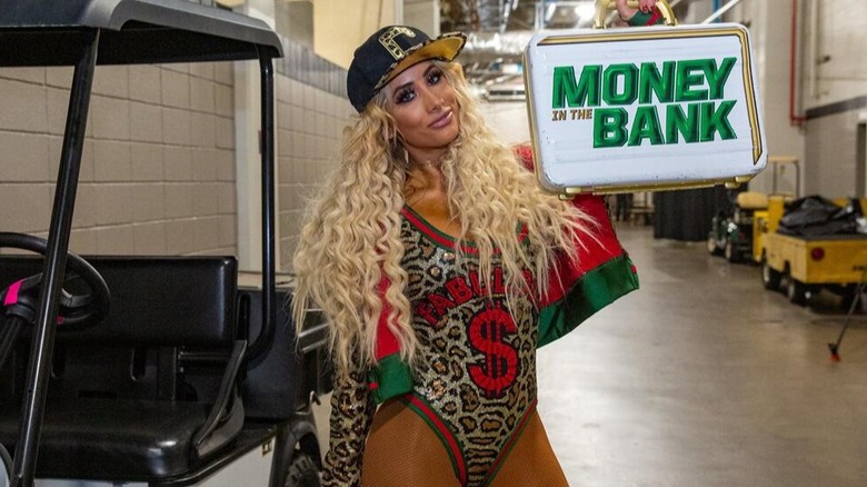 Carmella poses with her newly won Women's Money in the Bank briefcase in 2017