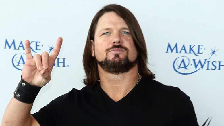 AJ Styles forming a Too Sweet gesture with his hand