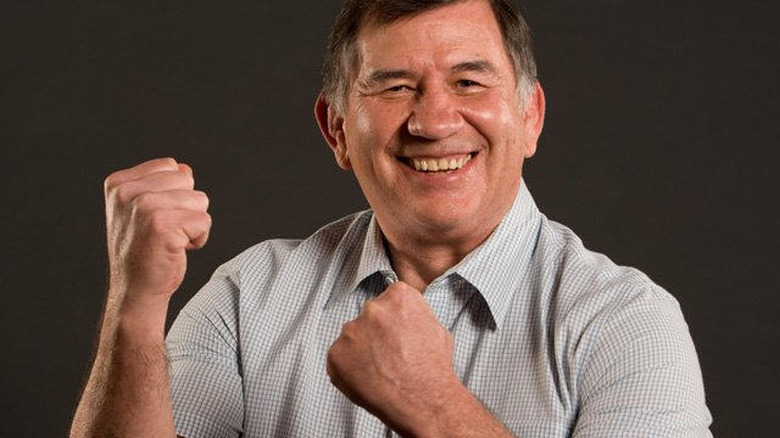 Gerald Brisco raising his fists with a smile on his face